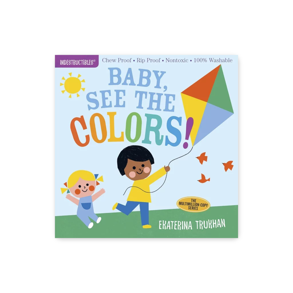Okładka książki „Baby, See the Colors!” z serii Indestructibles – dziecko z latawcem, kolorowe litery i ilustracje dla niemowląt