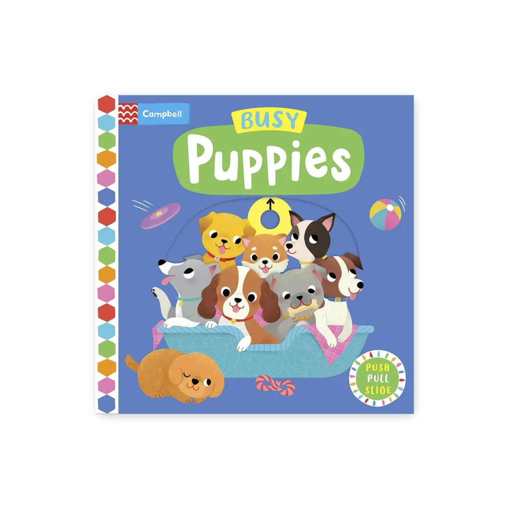 Okładka książeczki „Busy Puppies” z ruchomymi elementami, na której widoczne są urocze szczeniaki bawiące się na poduszce.